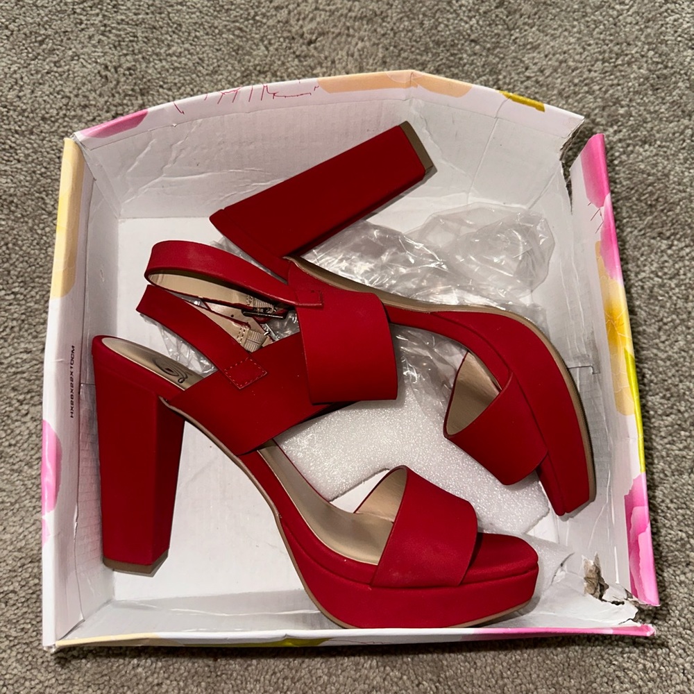 Red heals, never worn, size 8.5